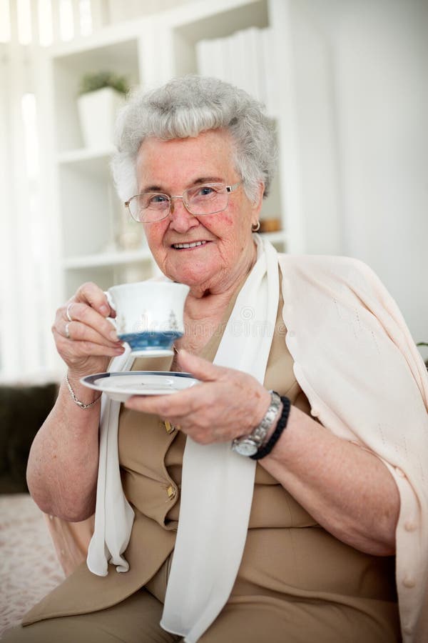 grandma-s-tea-old-woman-holding-cup-80133855.jpg