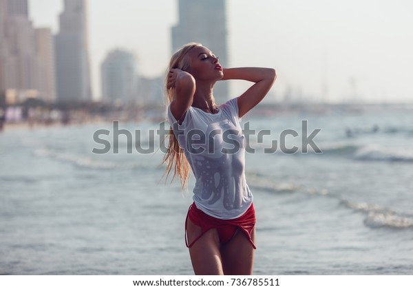 sexy-blonde-woman-wet-tshirt-600w-736785511.jpg